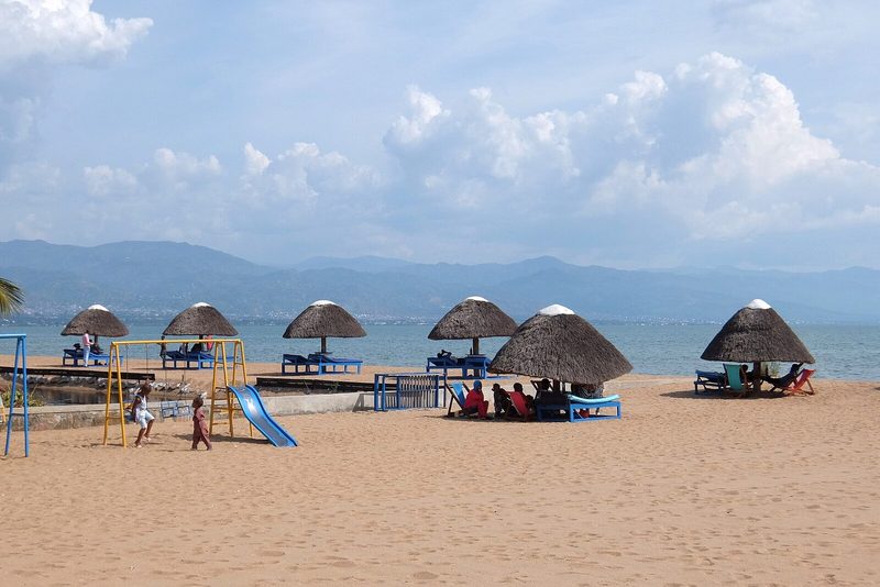 Sandy beach with thatched parasols at World Beach Bujumbura