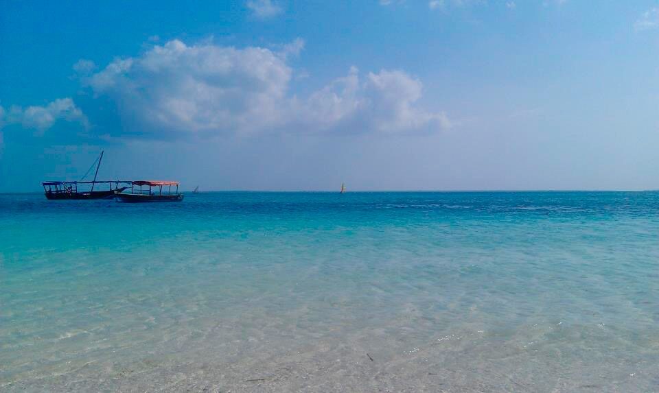 A traditional dhow on the turquoise water off Nungwi beach, Zanzibar