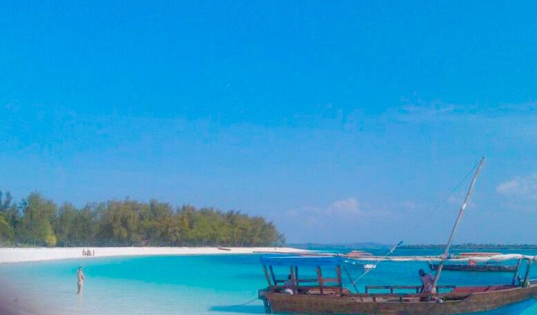A turquoise lagoon with a small boat off the north coast of Zanzibar
