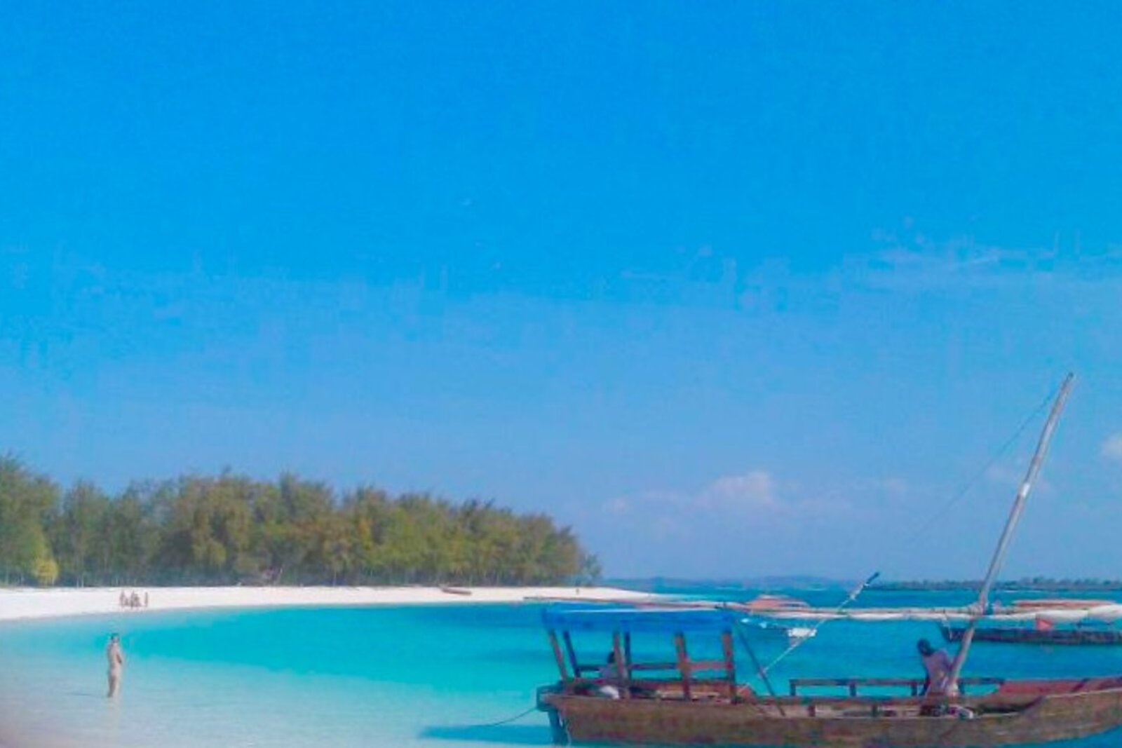 A wooden dhow on the turquoise shallows off Nungwi, Zanzibar