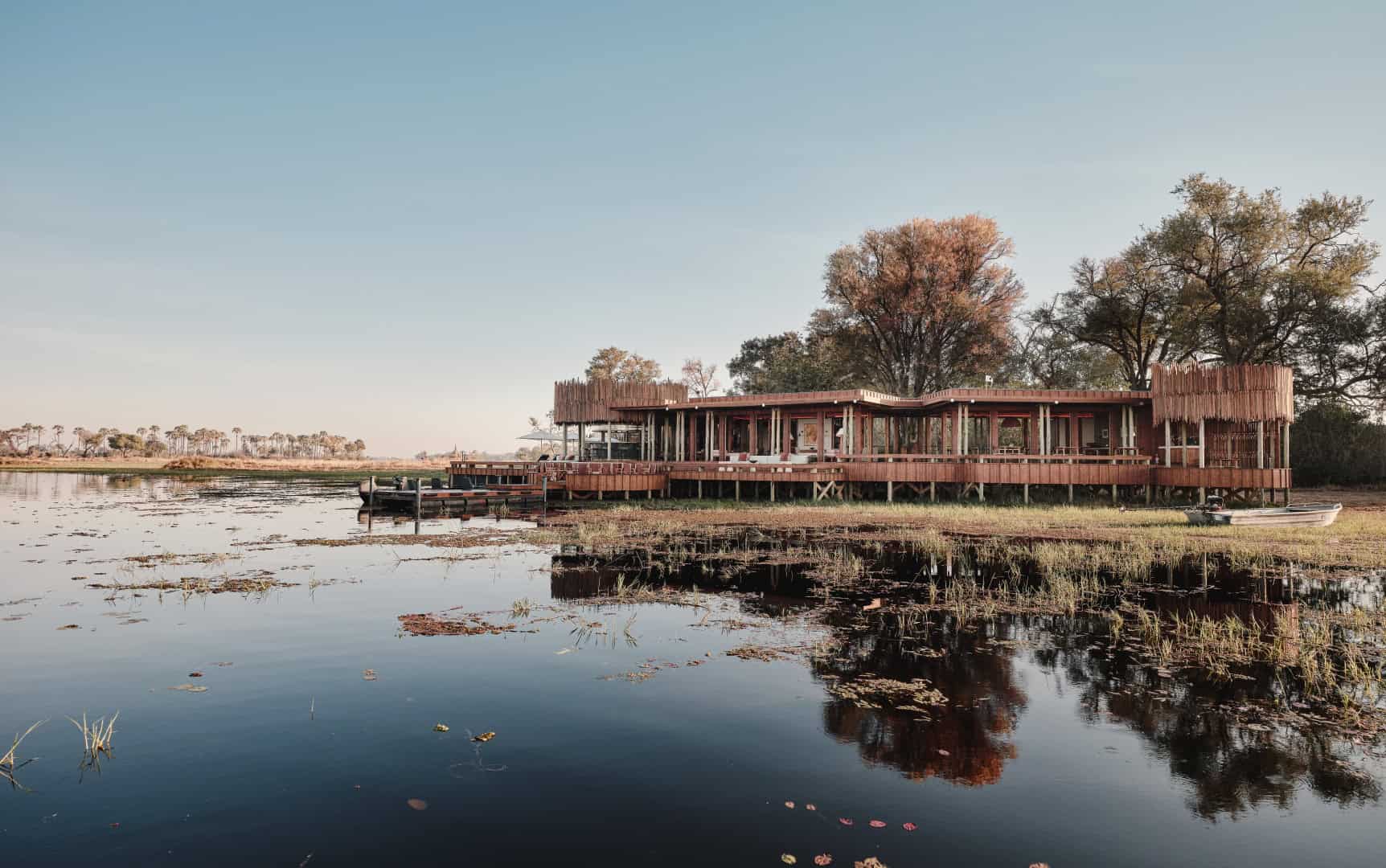 Sanctuary Baines' Camp raised on stilts above the Okavango Delta floodplains at dusk